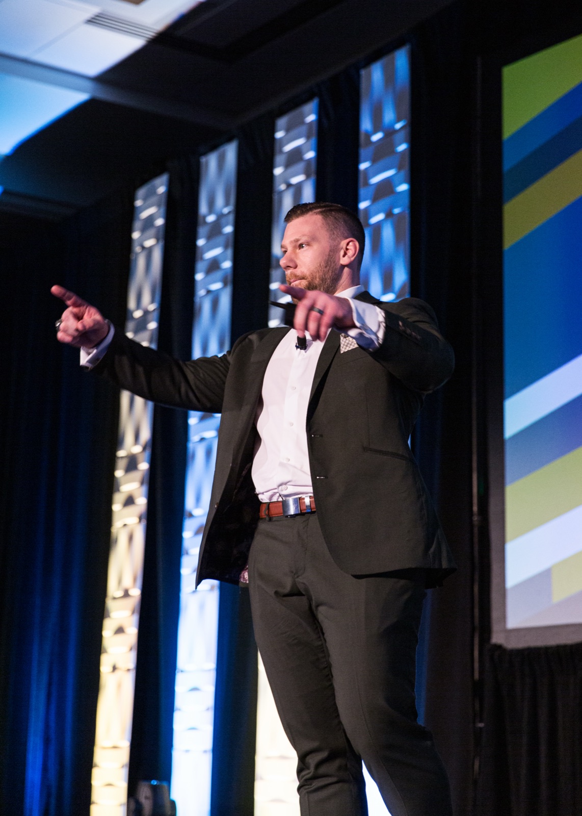 Josh Littauer leading a session on stage at a WealthWave convention